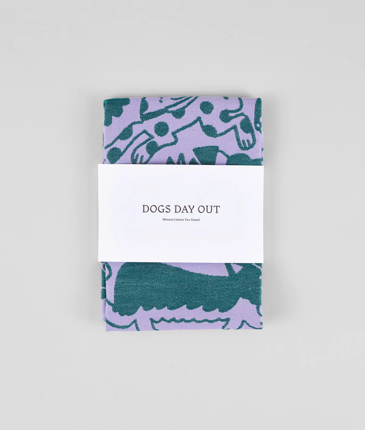 Folded dogs day out tea towel in green and purple by wrap illustration