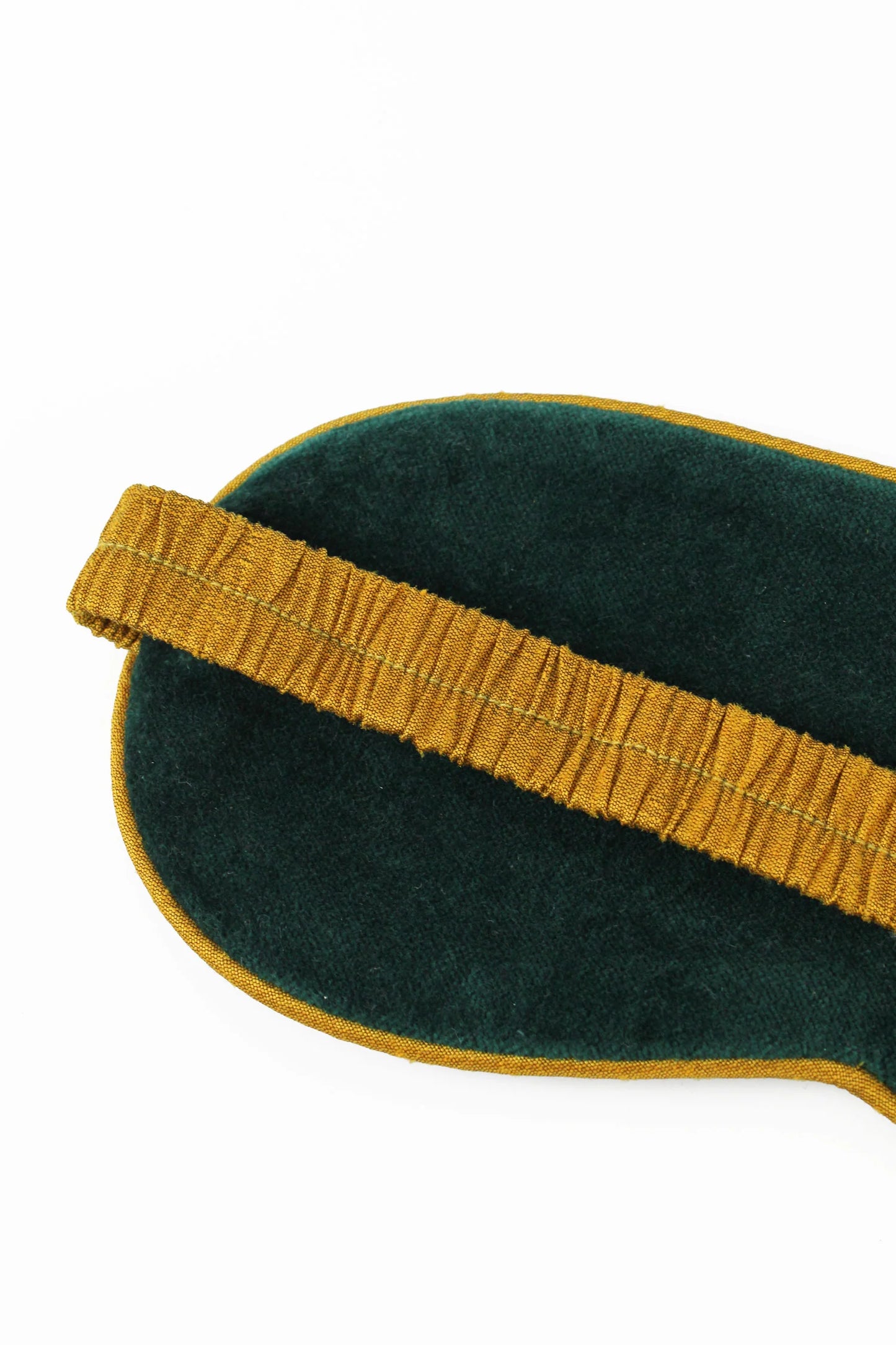 Back of eye mask showing the gold strap
