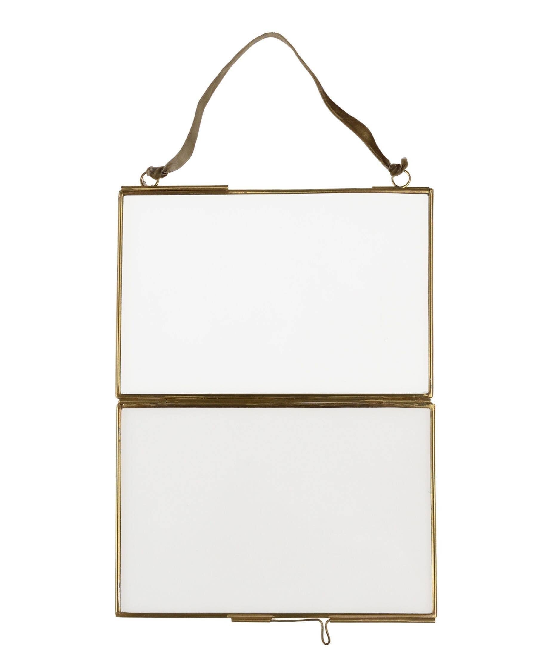 Hanging rectangular mirror with gold frame on a white background