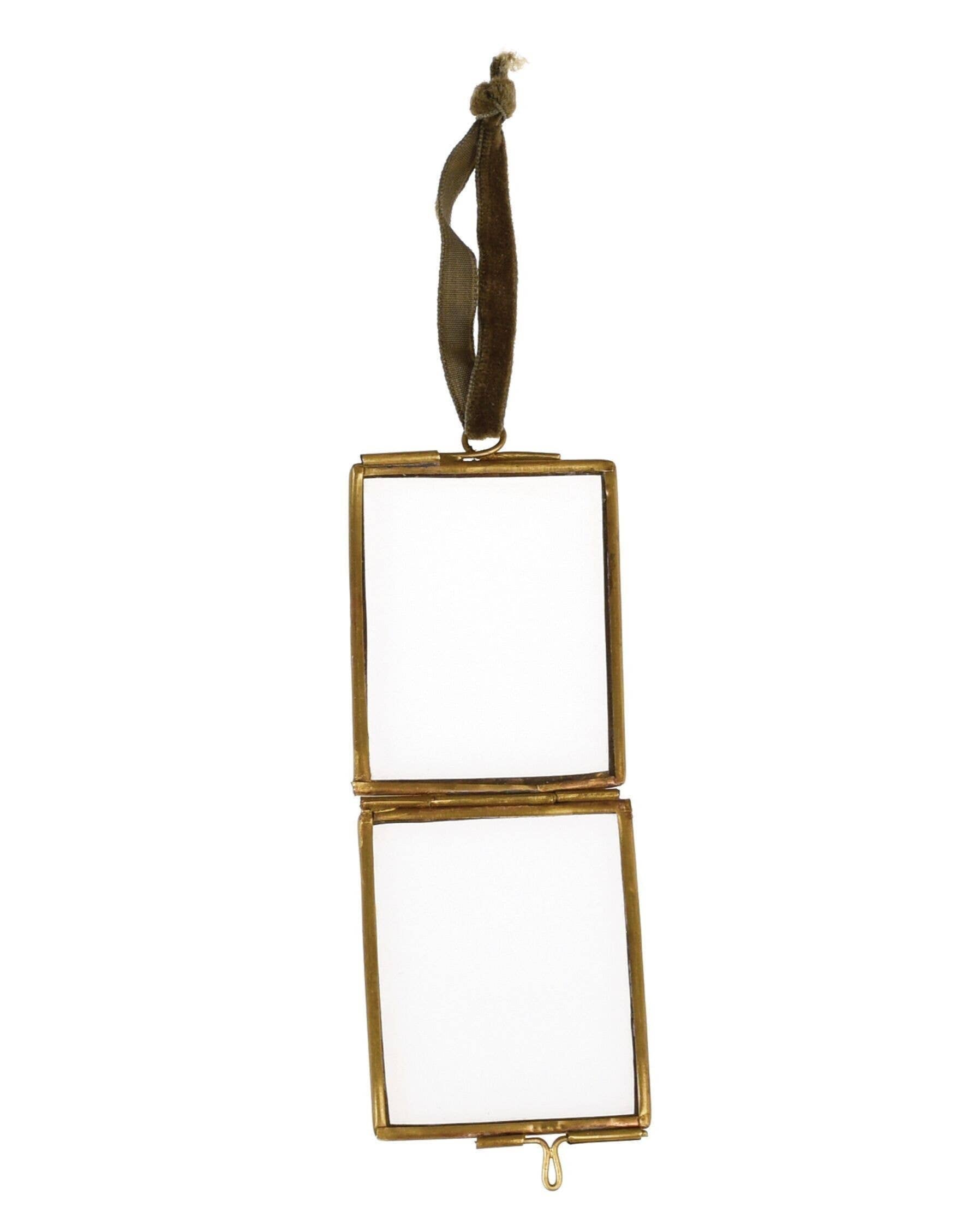 Gold rectangular mirror with ribbon on a white background
