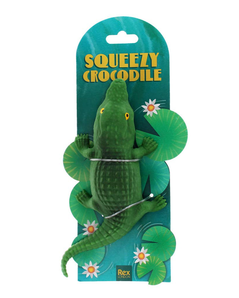 Green crocodile toy with packaging labeled 'Squeezy Crocodile' on a white background
