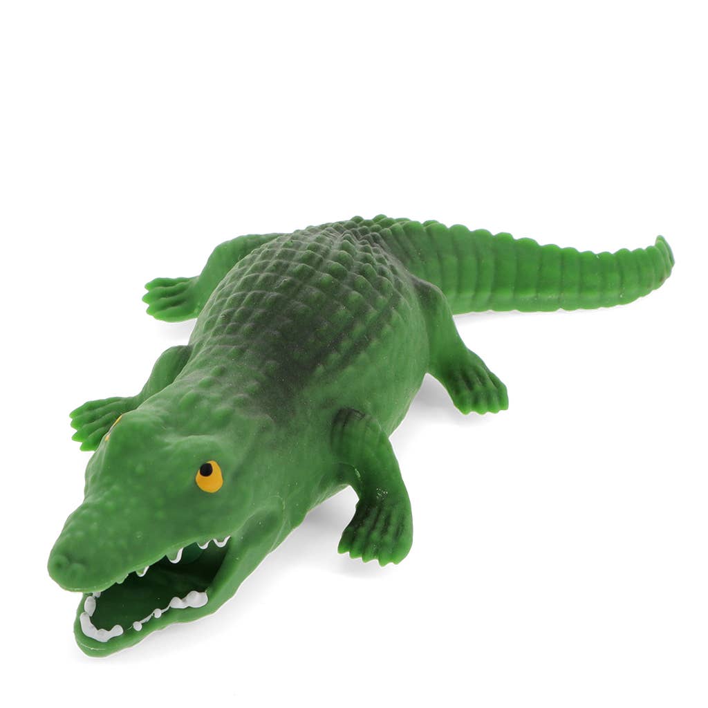Green toy alligator on a white background