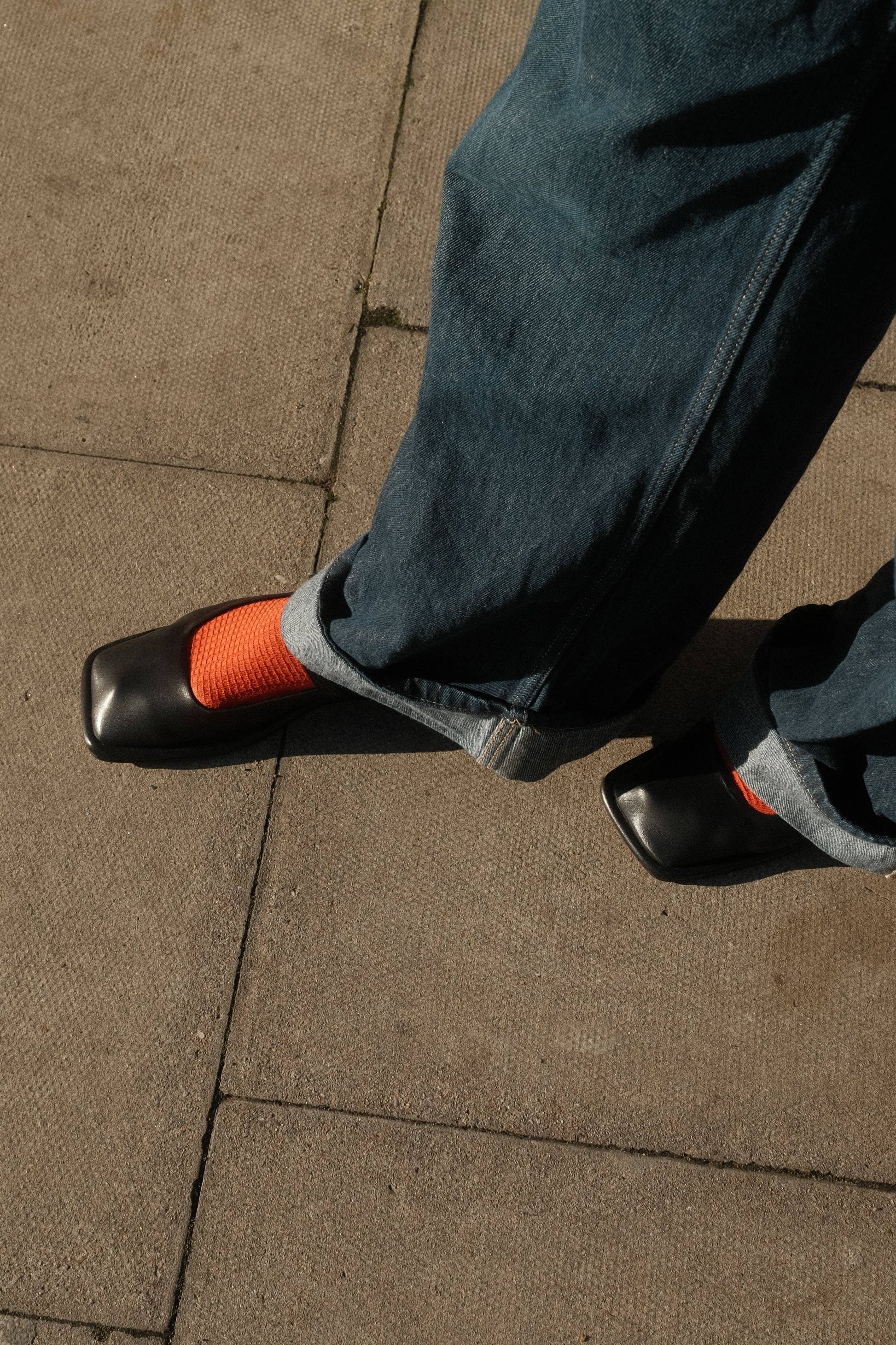 Lady wearing the waffle rust socks with black pump shoes