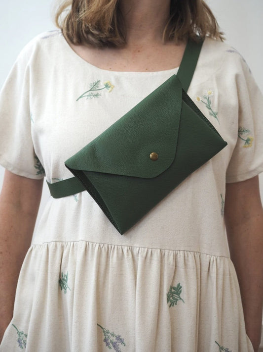 The versatile green Betty belt bag can be worn around the waist or across the body, thanks to its fully adjustable strap