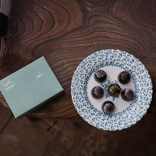 Six vegan dark chocolate hazelnut truffles made with organic dark chocolate and a tasty hazelnut filing by Harth