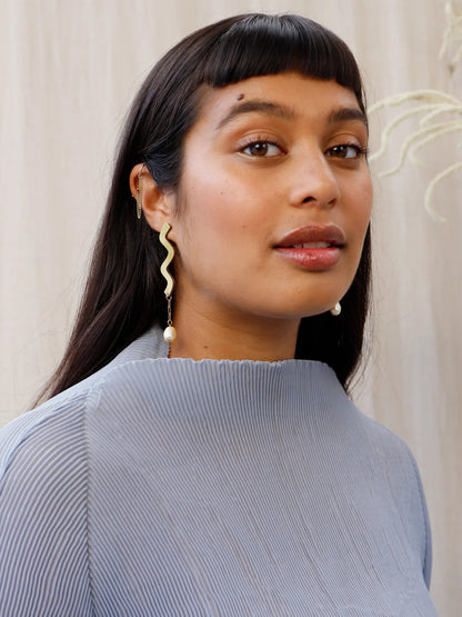 Wavy asymmetric statement earrings made in brass with Wolf & Moon's signature wood base, Czech glass baroque pearls, 14k gold-filled chain and sterling silver earring posts. 