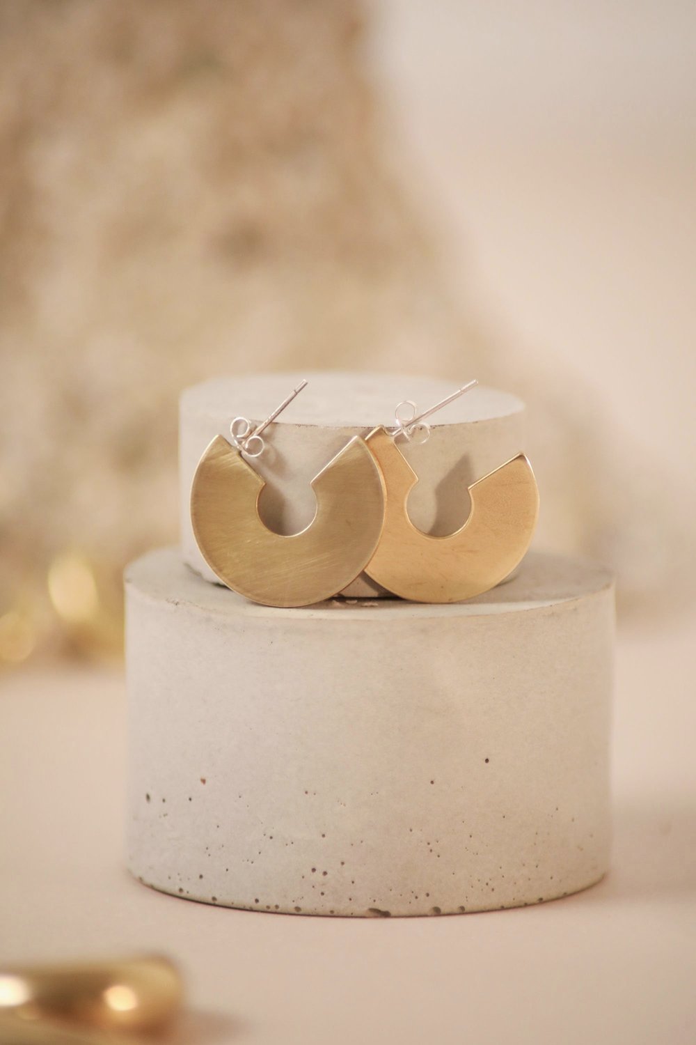 The Every Space brass and silver Astrid hoop earrings by Roake Studio
