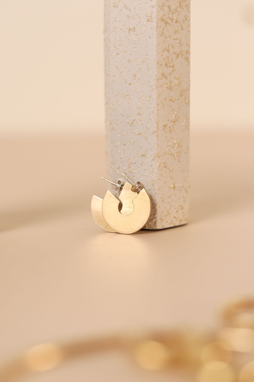 The Every Space brass and silver Astrid hoop earrings by Roake Studio