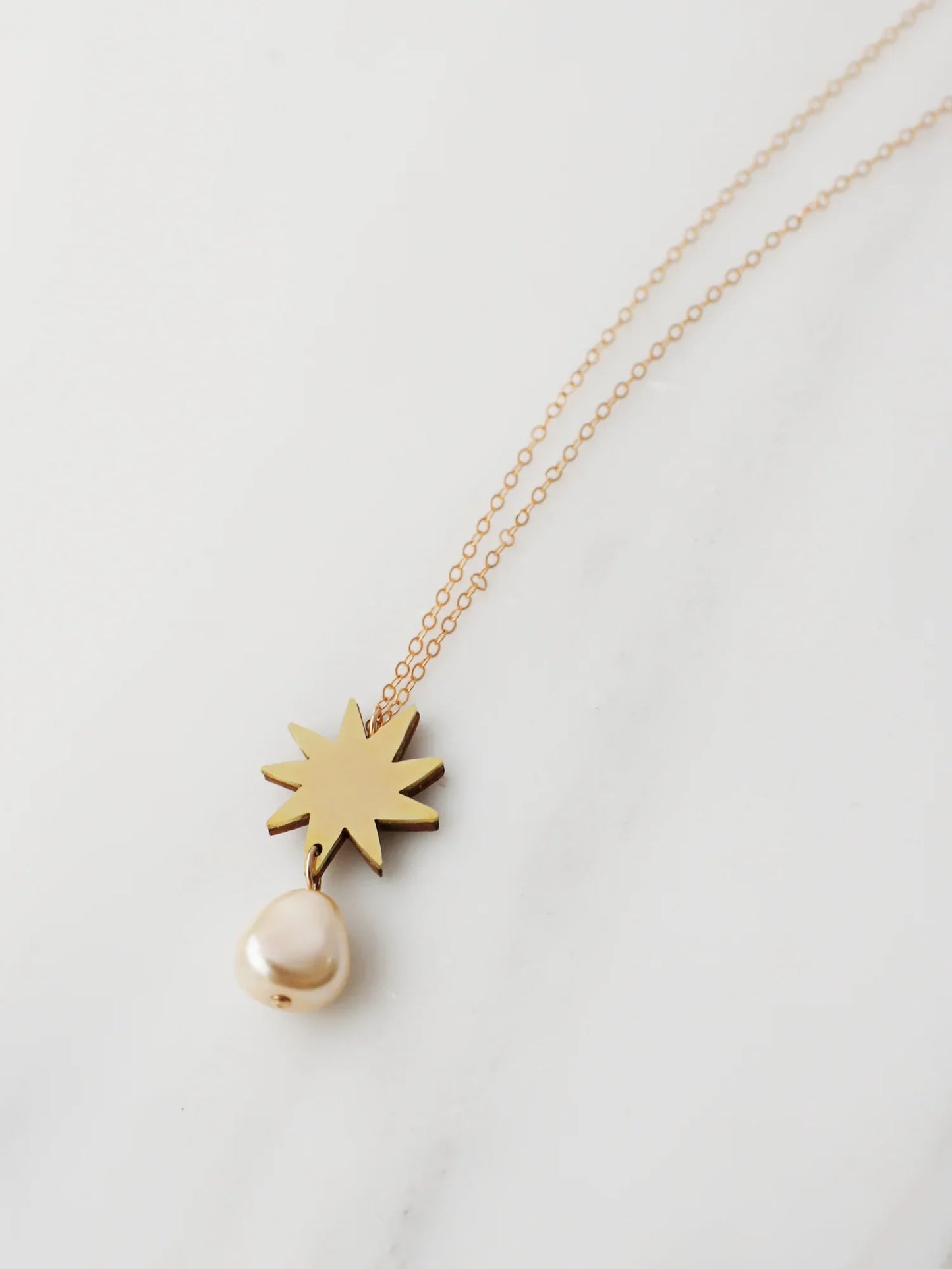 The Every Space Kara necklace with gold filled chain and brass pendant by Wolf & Moon