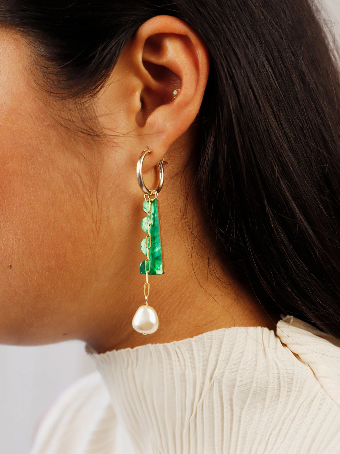 The Every Space mismatched Martha hoop earrings with gold filled hoops and emerald & brass charms by Wolf & Moon