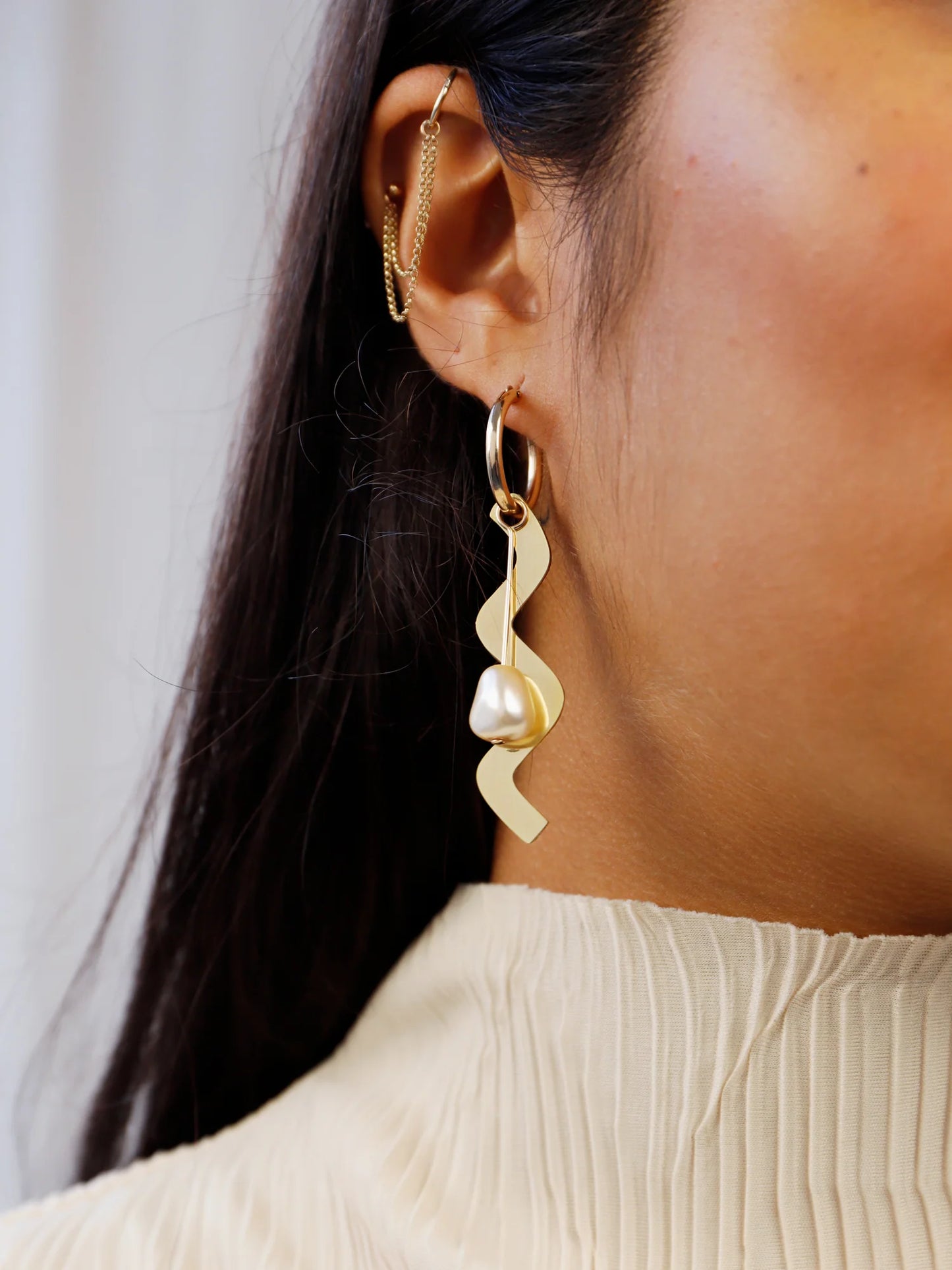 The Every Space mismatched Martha hoop earrings with gold filled hoops and emerald & brass charms by Wolf & Moon