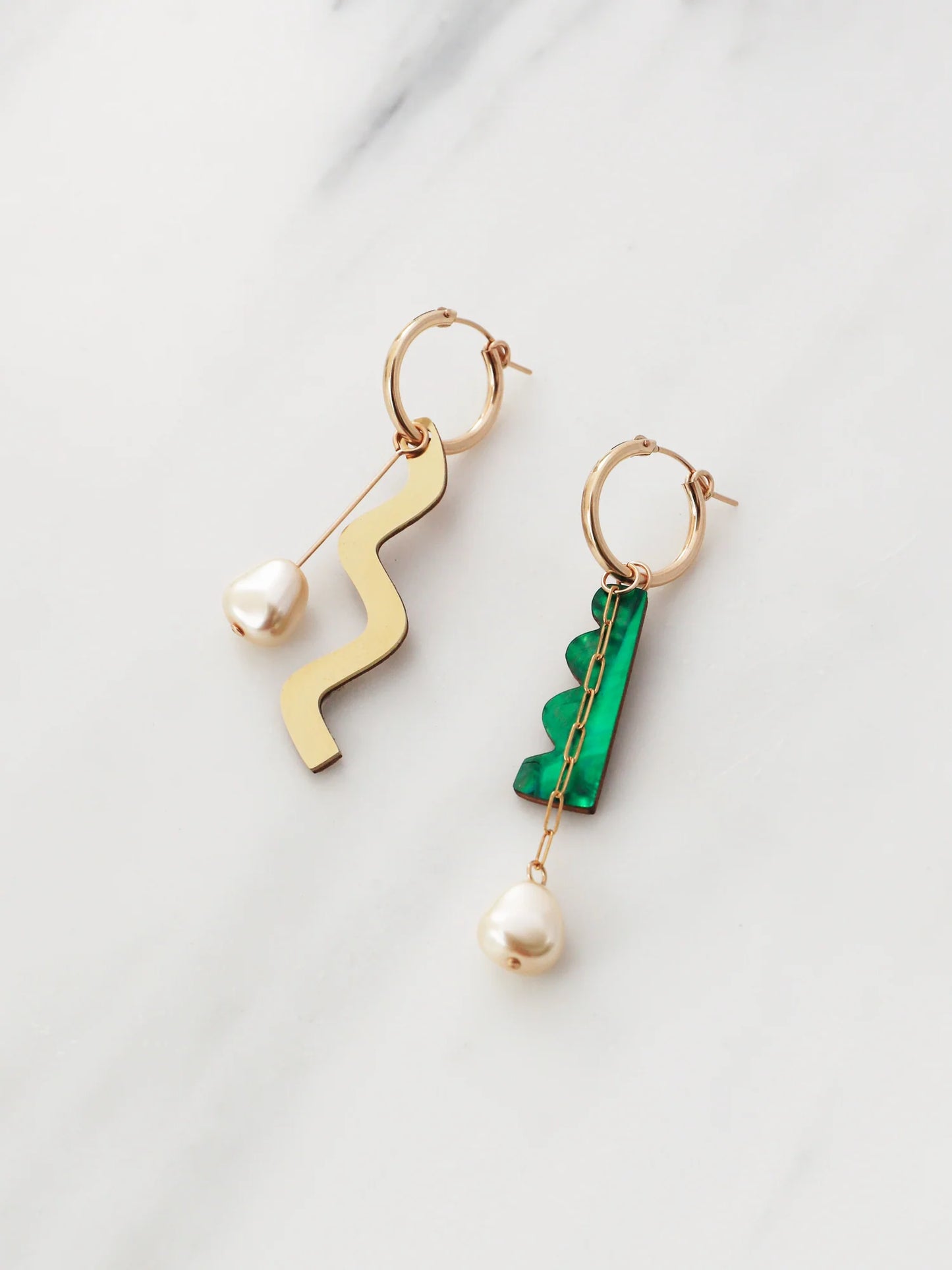 The Every Space mismatched Martha hoop earrings with gold filled hoops and emerald & brass charms by Wolf & Moon