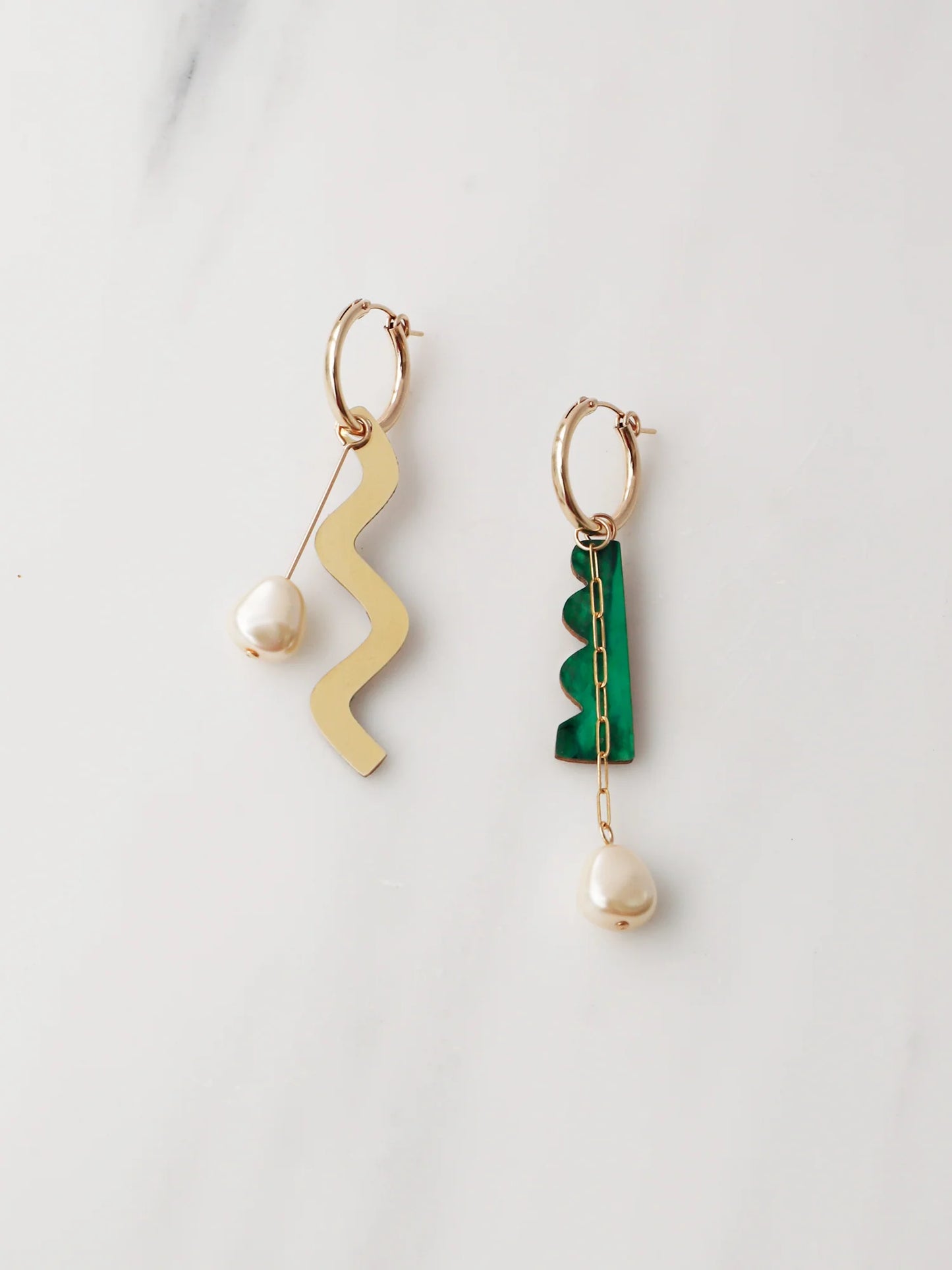 The Every Space mismatched Martha hoop earrings with gold filled hoops and emerald & brass charms by Wolf & Moon