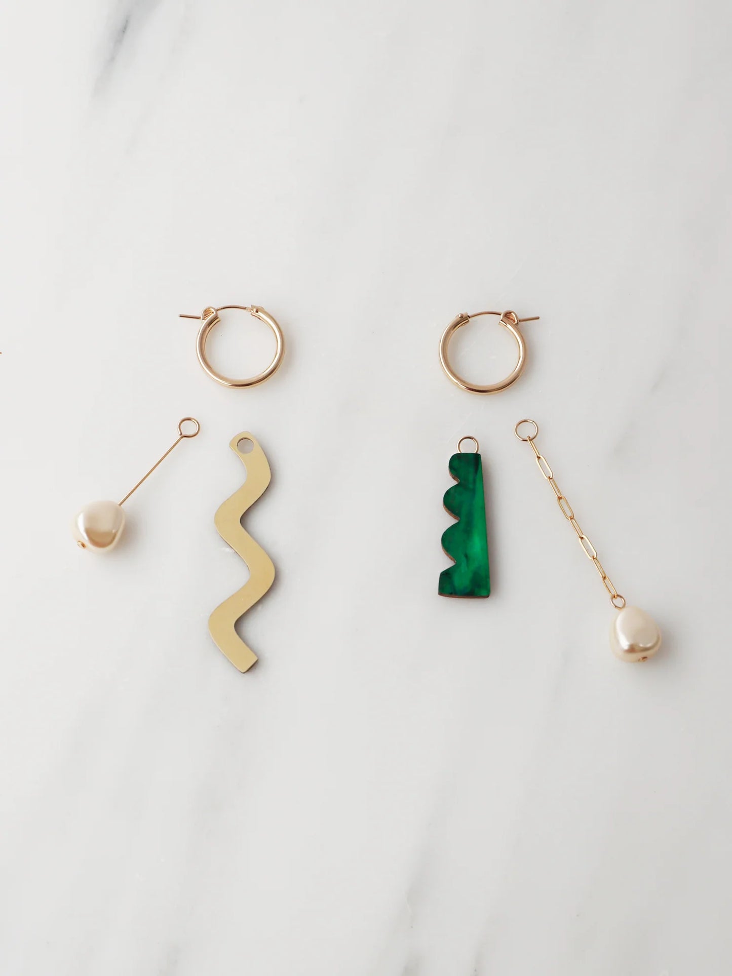The Every Space mismatched Martha hoop earrings with gold filled hoops and emerald & brass charms by Wolf & Moon