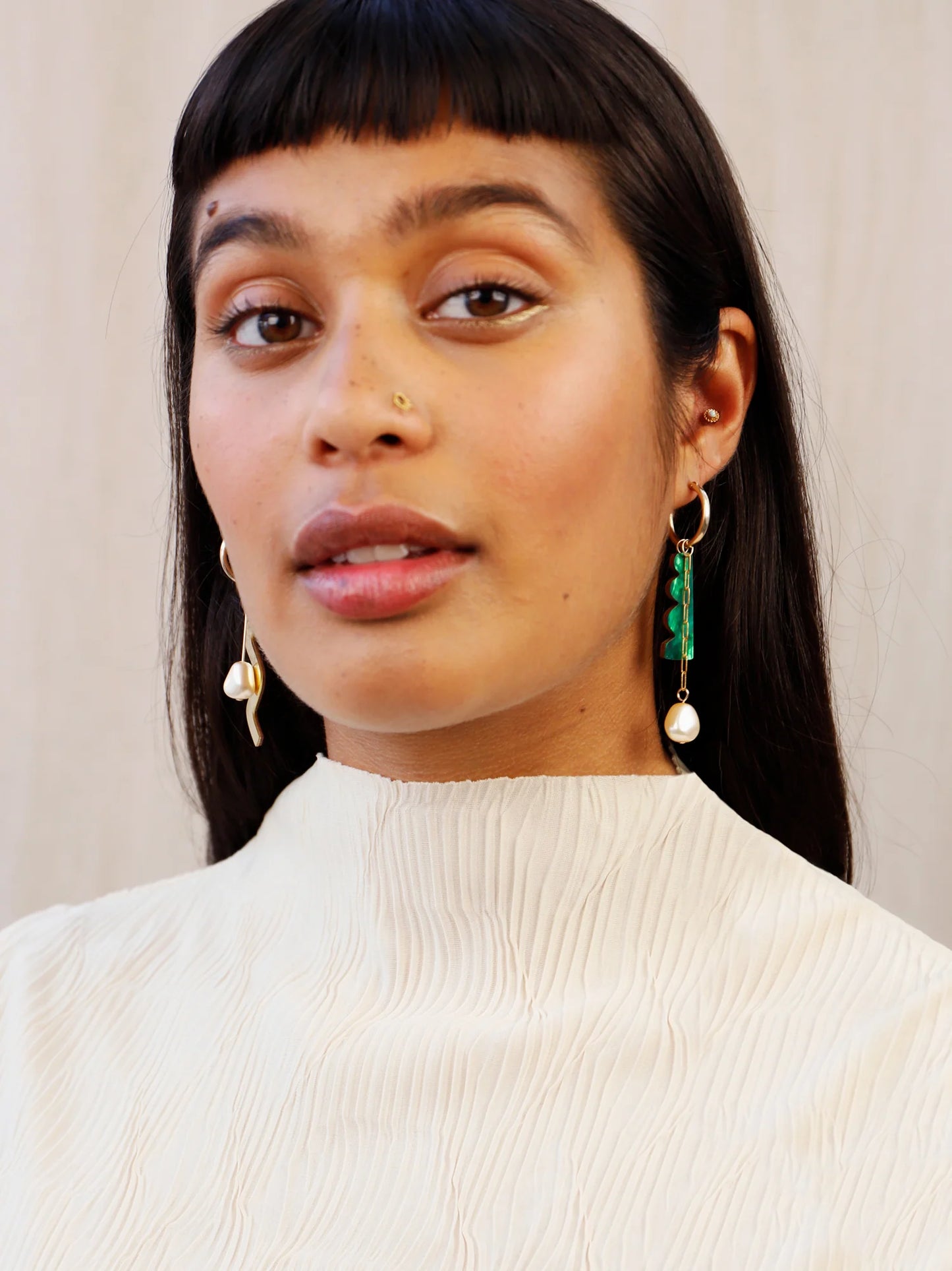 The Every Space mismatched Martha hoop earrings with gold filled hoops and emerald & brass charms by Wolf & Moon