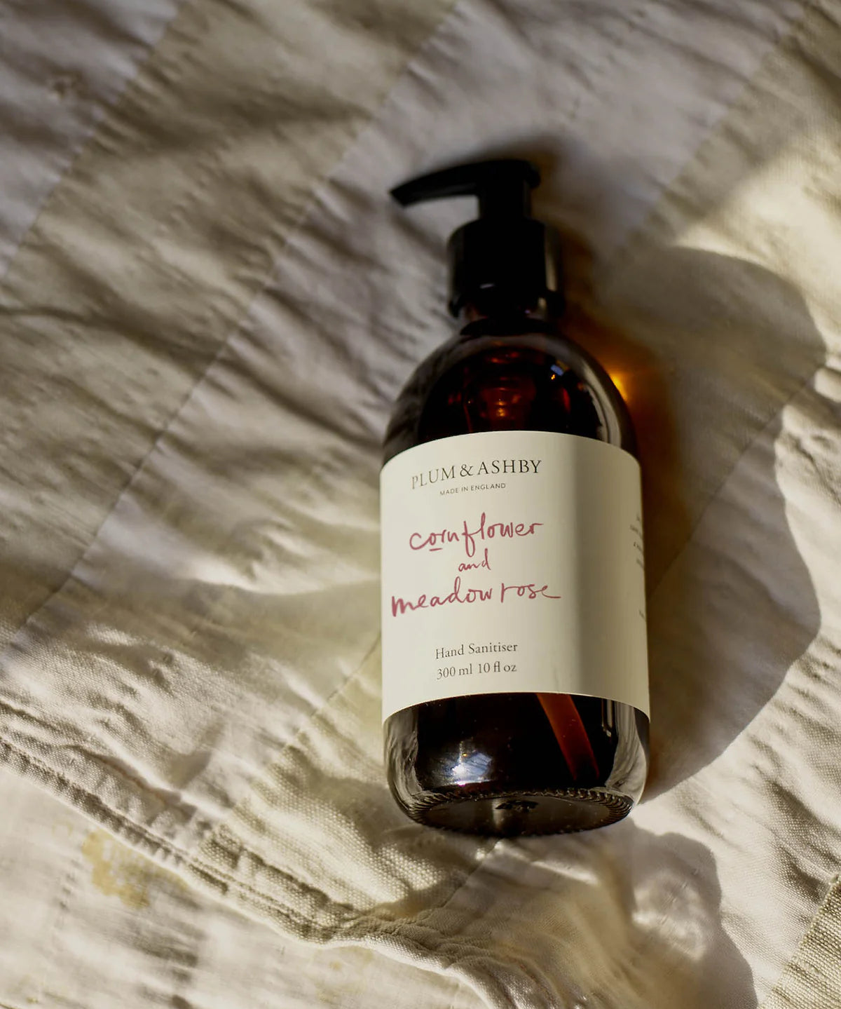 Cornflower and Meadow Rose Hand & Body Wash by Plum & Ashby in an amber glass bottle with pump