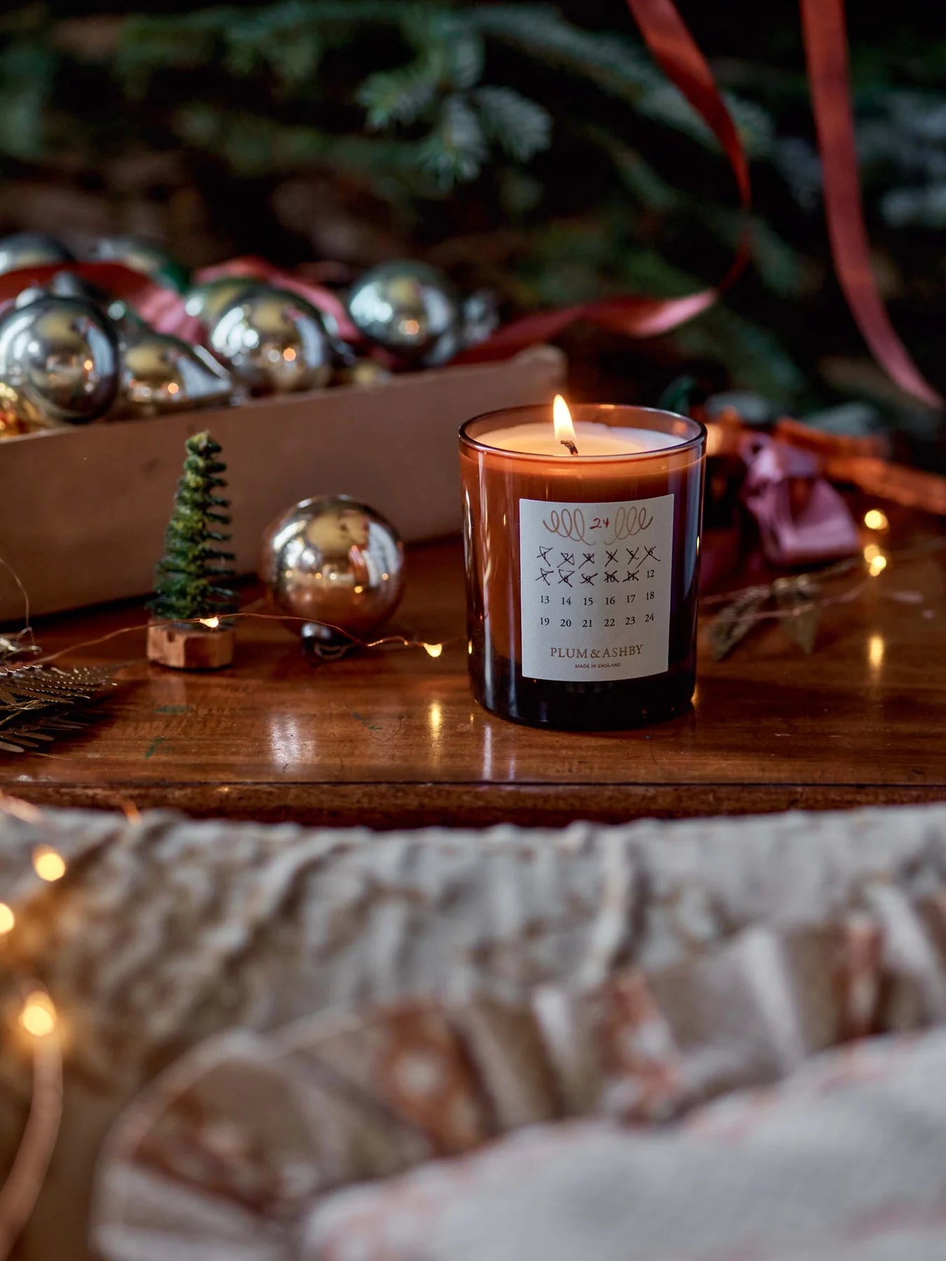 The Every Space Cedarwood and Pine Needle seasonal advent candle by Plum & Ashby presented in a gift box with detachable Christmas decoration