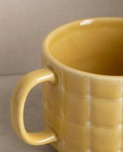 Egg Back Home yellow mug with textured surface on a neutral background
