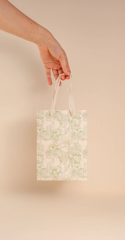 Pale green, jungle print gift bag by Cai & Jo is plastic-free and zero waste.  Nontoxic, plastic-free, reusable, and includes speckled cotton handles.