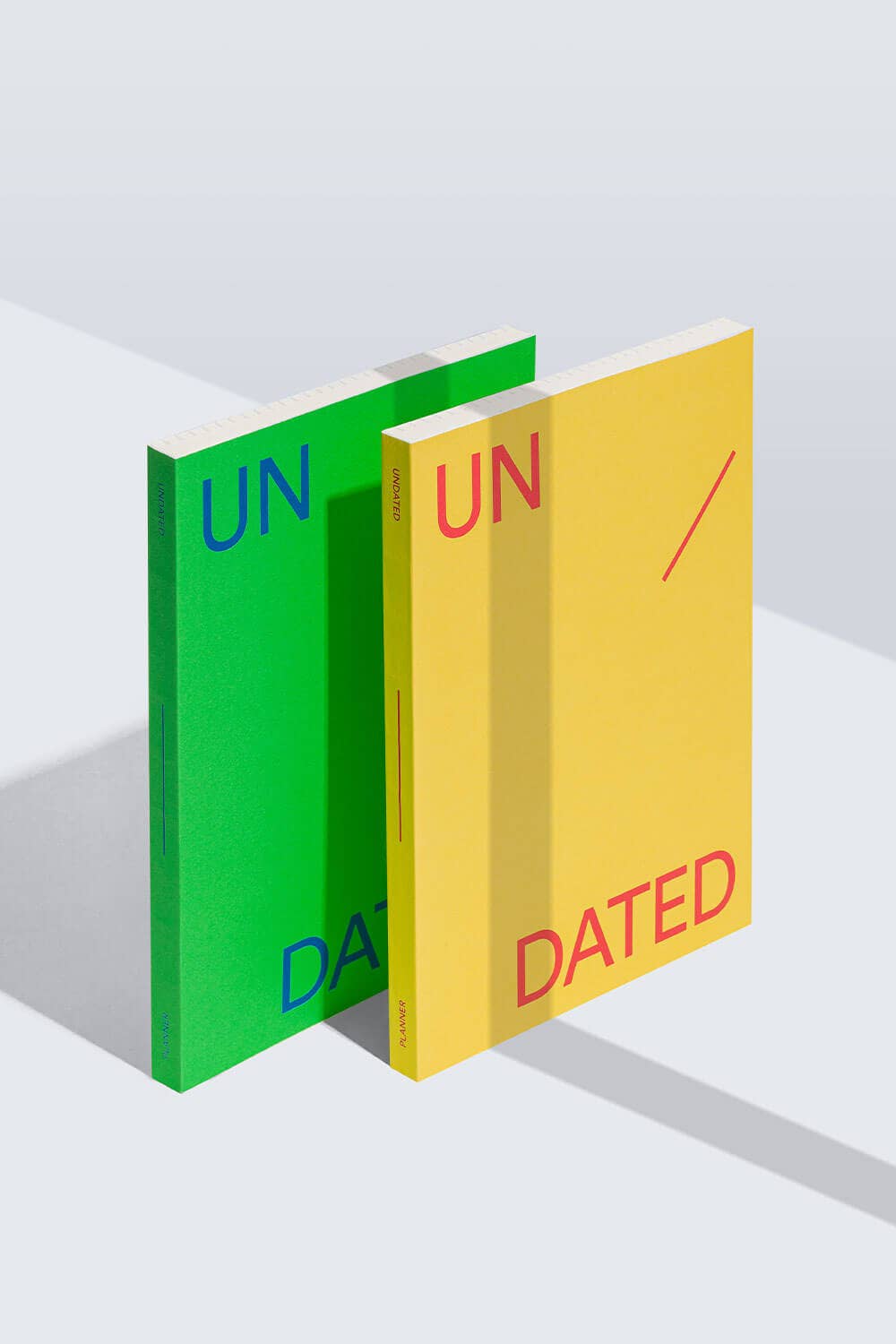 Two books, one green and one yellow, with 'UNDATED' text on a white background.