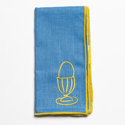 Close up of the embroidered egg design on a linen napkin