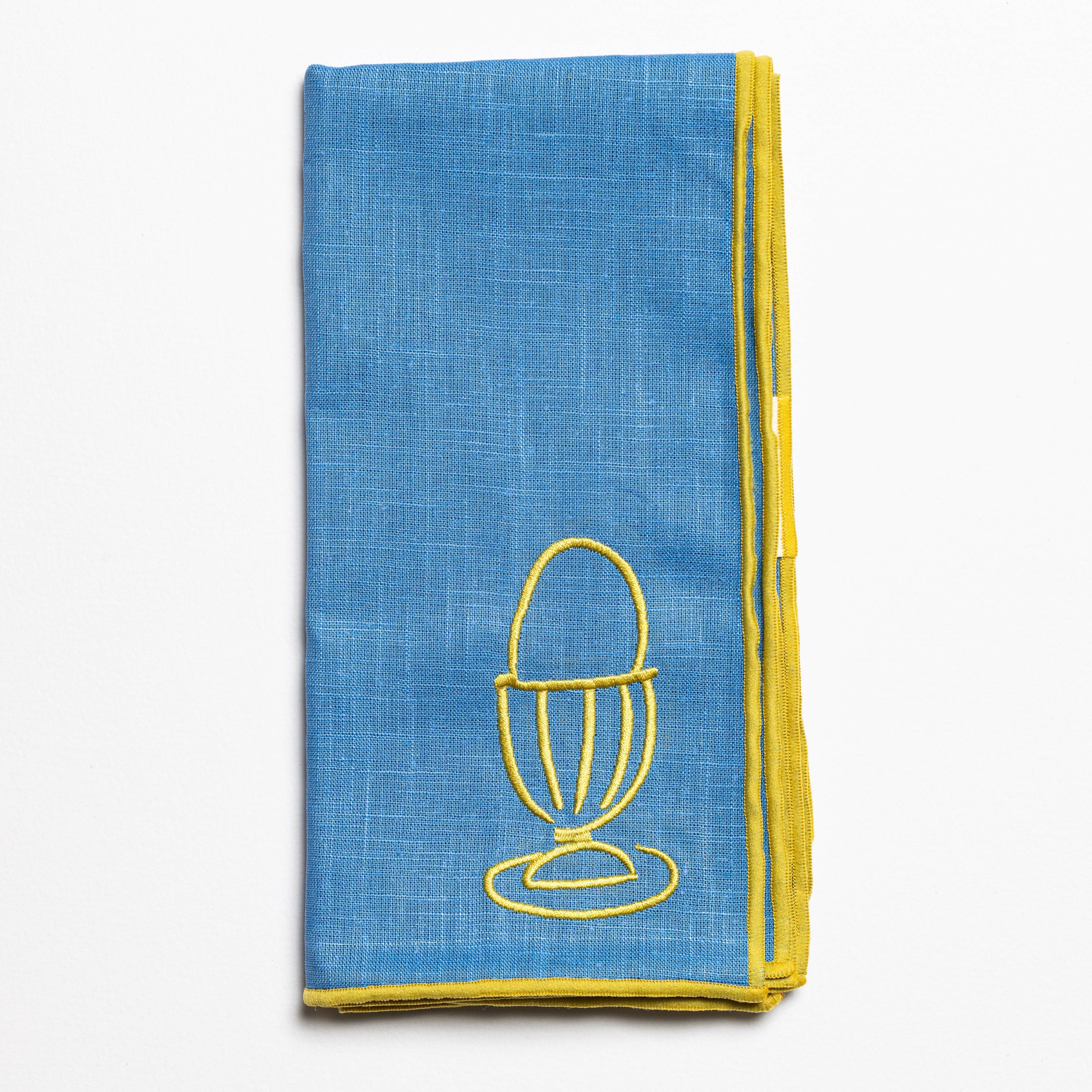 Close up of the embroidered egg design on a linen napkin