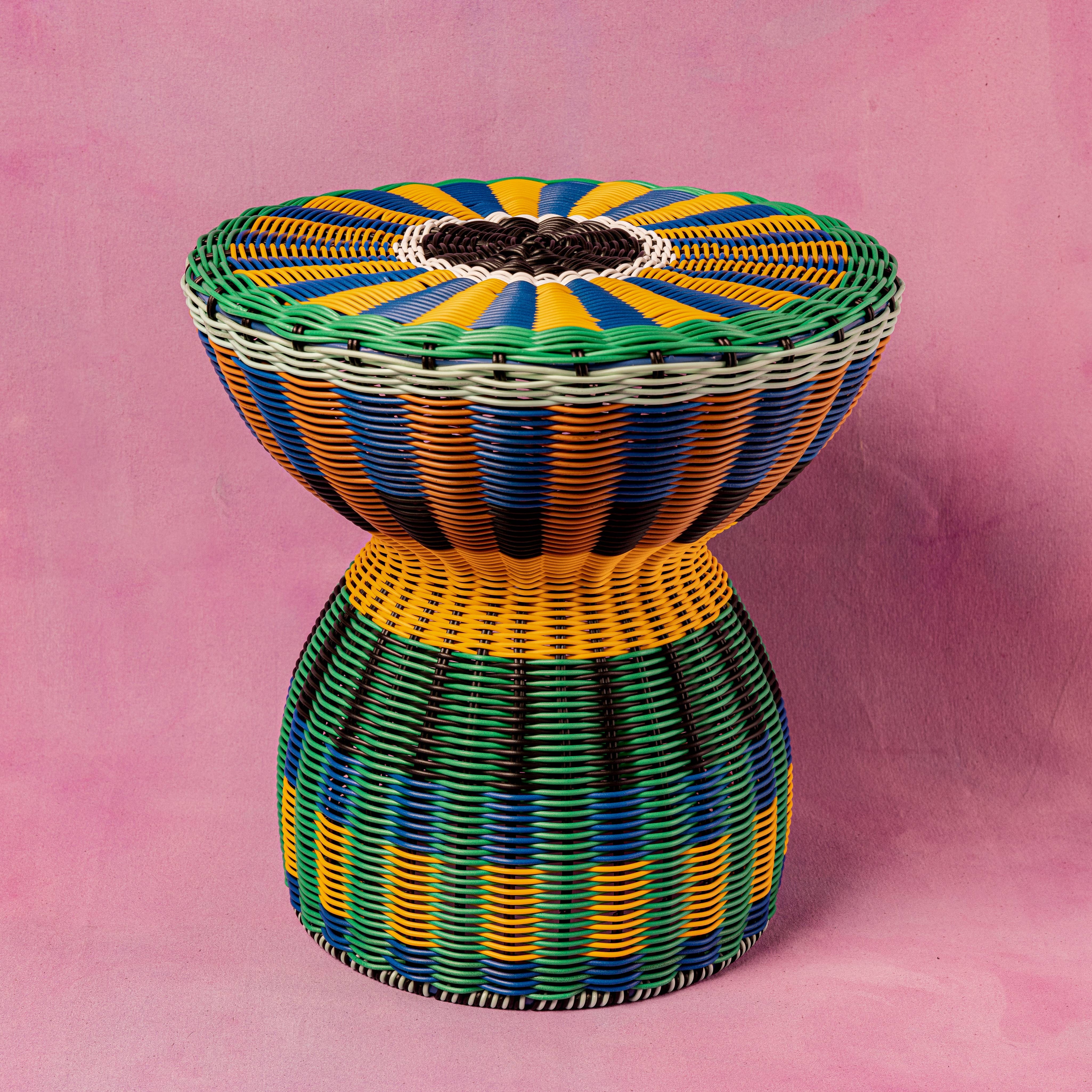 Hand woven faux rattan accent table in blue and yellow, by MÆGEN