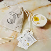Burning Bright Abundance candle with citrine crystal and buttercup topping