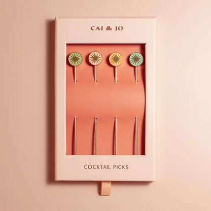 Set of 4 gold metal cocktail picks, by Cai & Jo, has pastel coloured sun heads and comes packaged in a gift box.