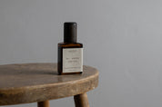 Be Where You Are pulse point roll by Quiet Hours, in an amber bottle on a wooden stool