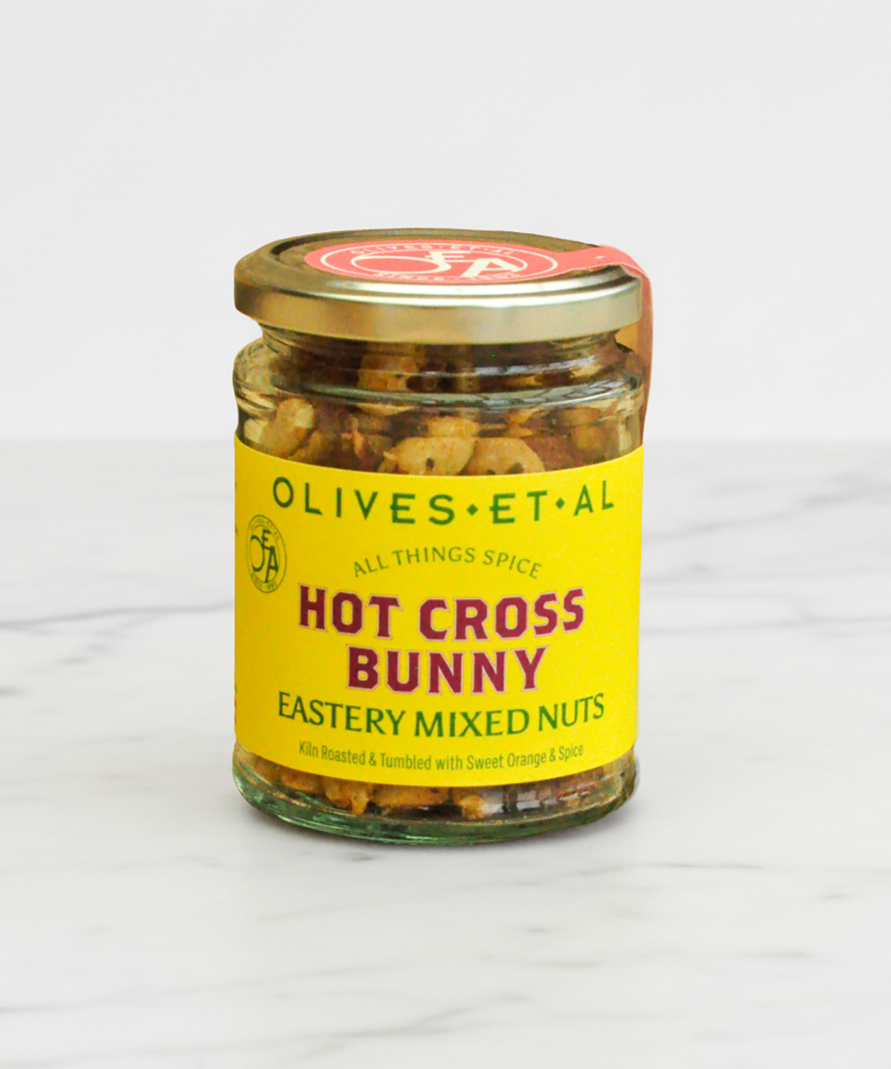 Jar of 'Hot Cross Bunny' mixed nuts with a yellow label on a white background
