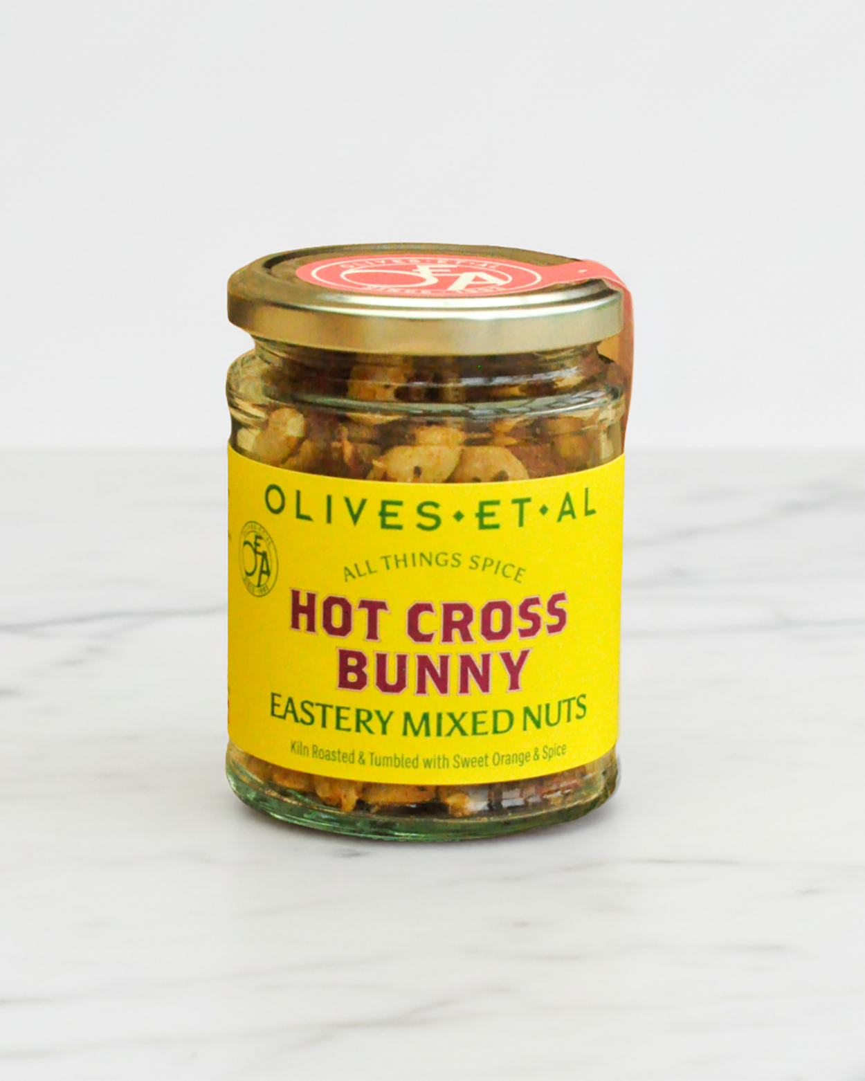 Jar of 'Hot Cross Bunny' mixed nuts with a yellow label on a white background