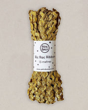 Gold ric rac ribbon with a label on a beige background