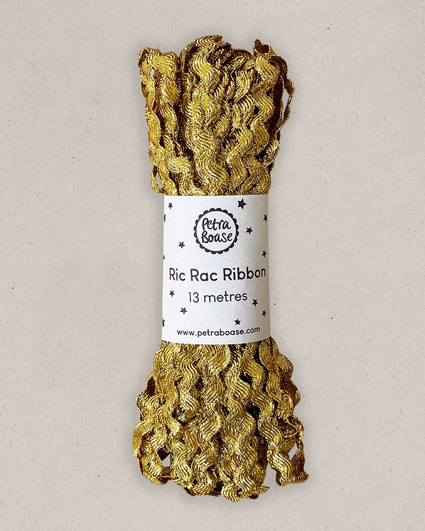 Gold ric rac ribbon with a label on a beige background