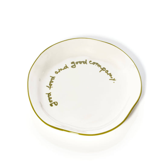 White plate with green rim and text that says 'good food and good company'