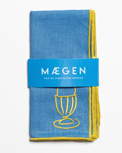 Blue linen blend napkins with embroidered egg motif in a branded sleeve