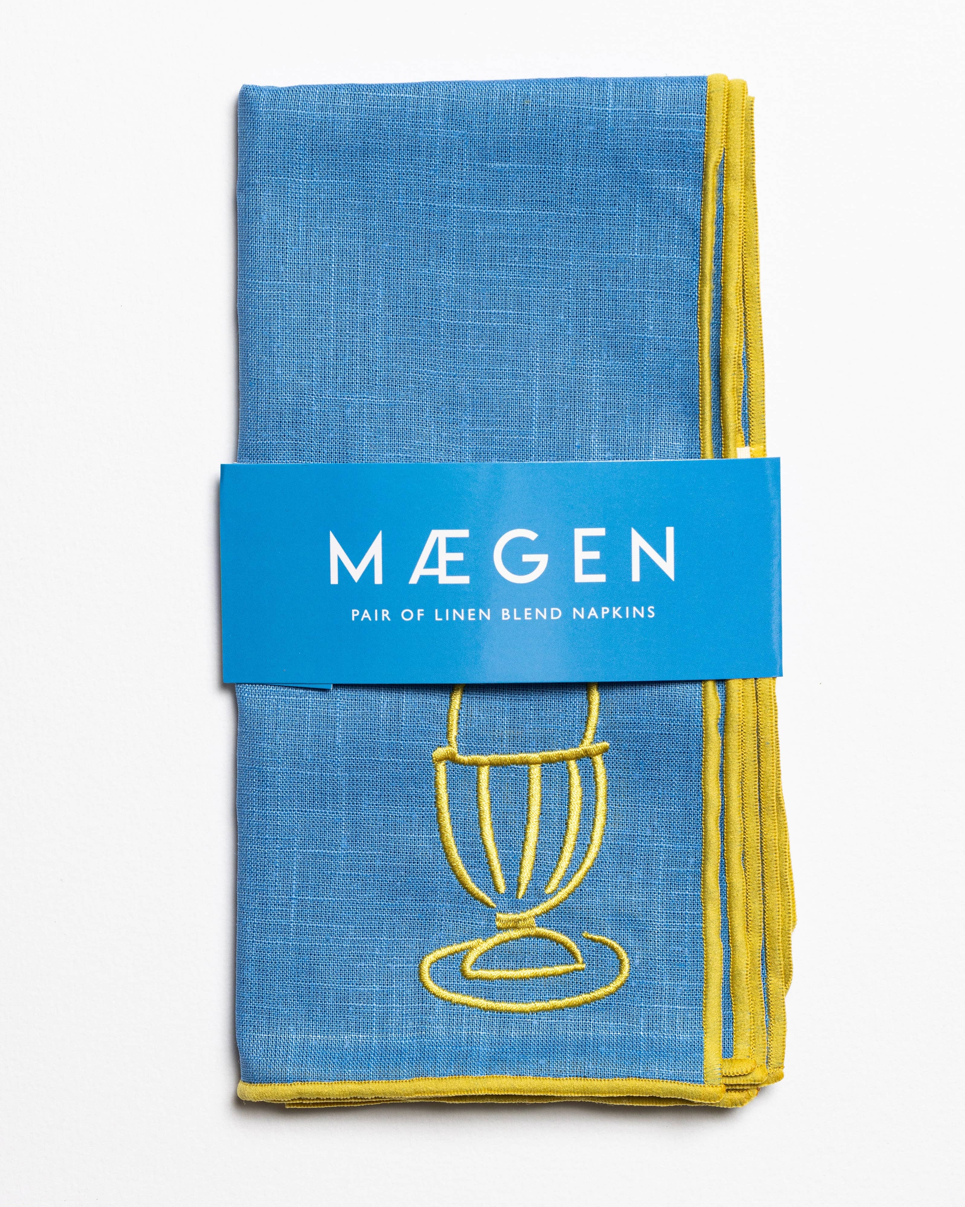Blue linen blend napkins with embroidered egg motif in a branded sleeve