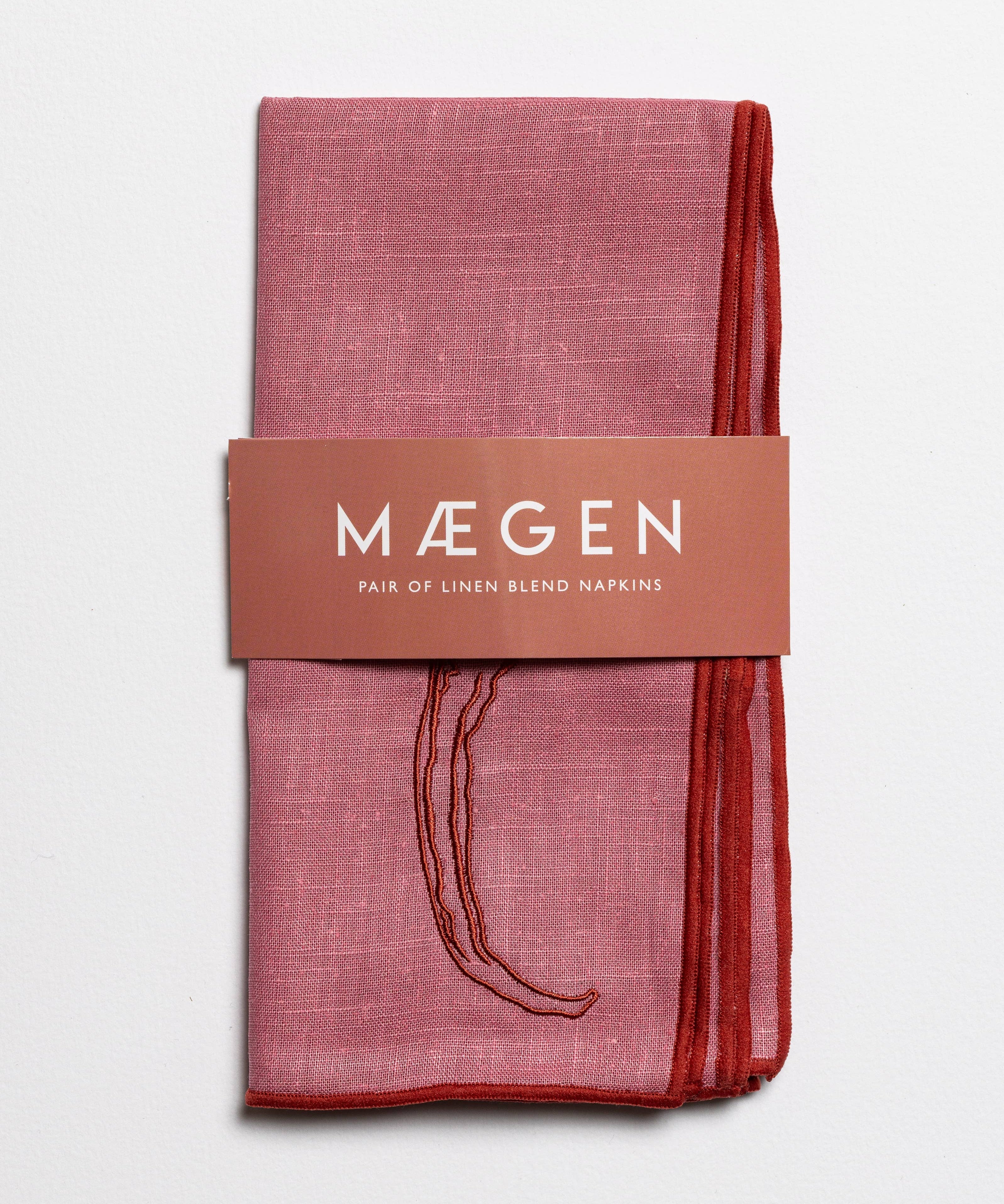 Red linen blend napkins with embroidered chilli motif in a branded sleeve