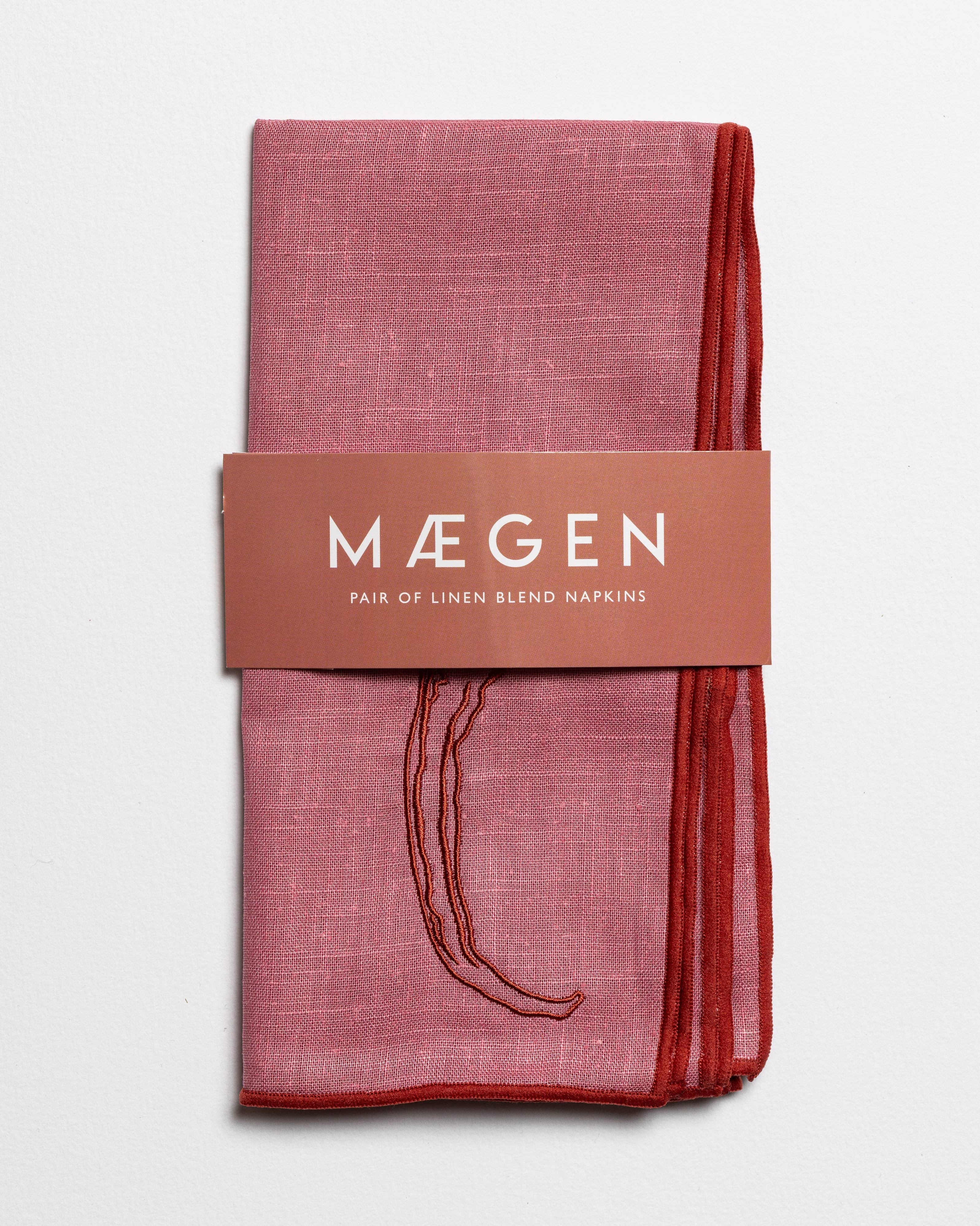 Red linen blend napkins with embroidered chilli motif in a branded sleeve