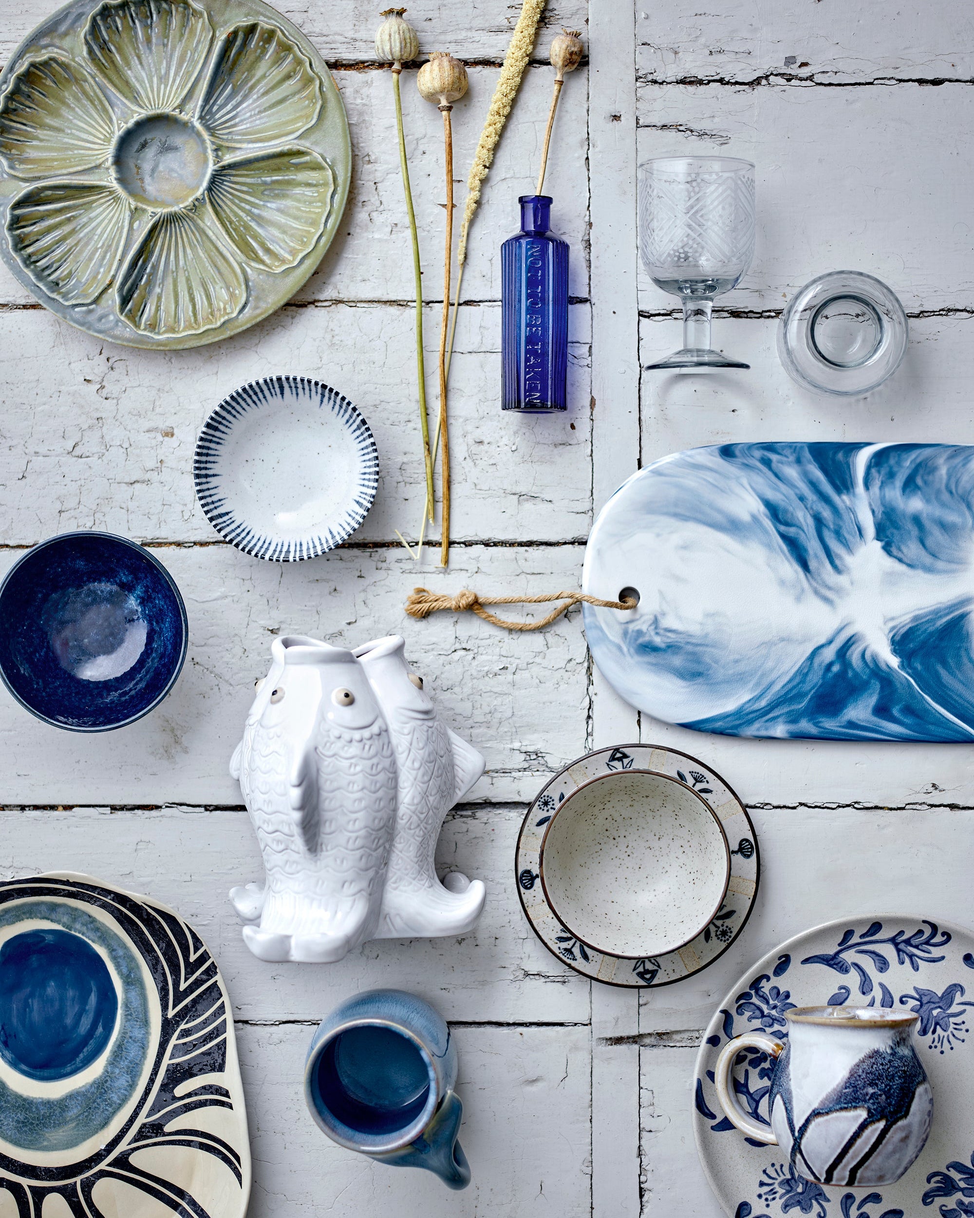Collection of ceramic dishes and decorative items on a wooden surface