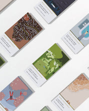 Collection of small books or notebooks with various designs on a white background