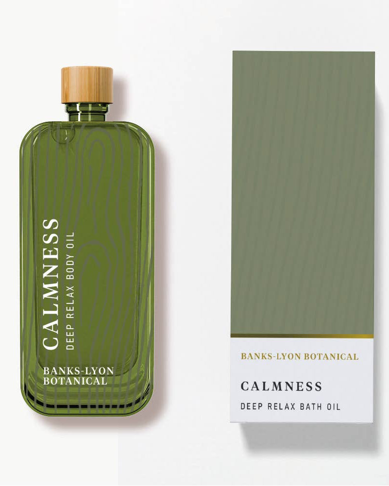Green bottle of 'Calmness' deep relax bath oil with a matching box on a white background