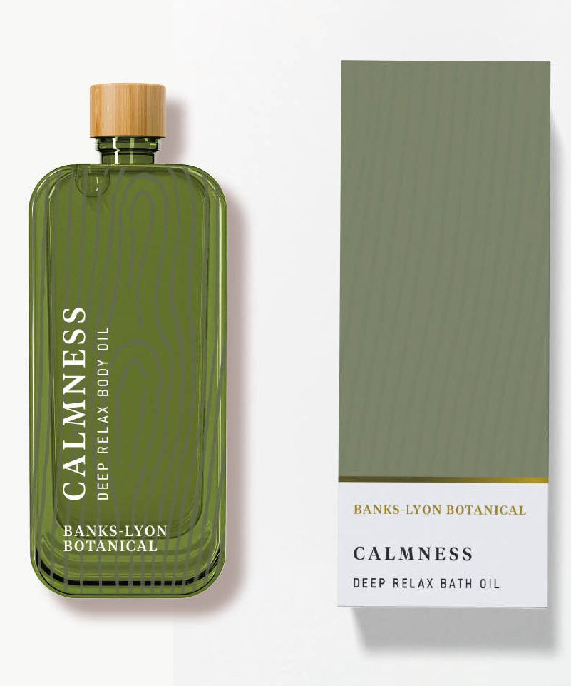 Green bottle of 'Calmness' deep relax bath oil with a matching box on a white background