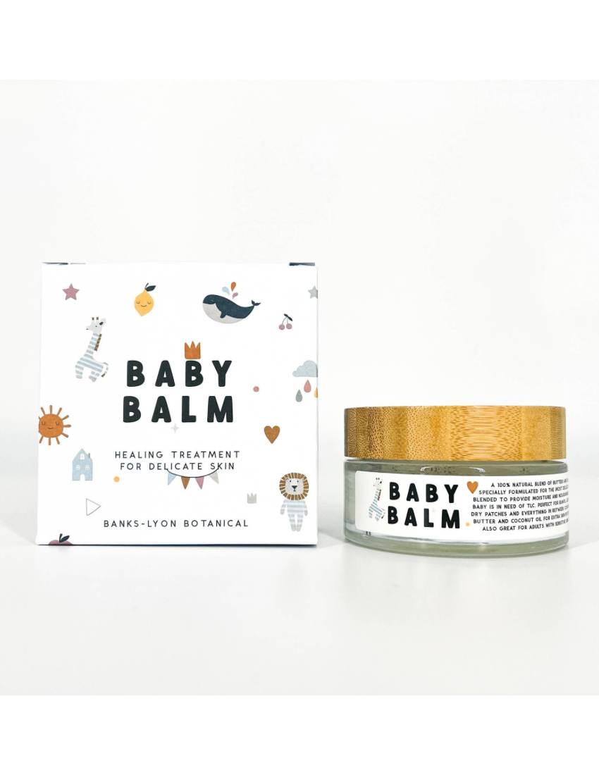 Baby balm jar with wooden lid and packaging on a white background