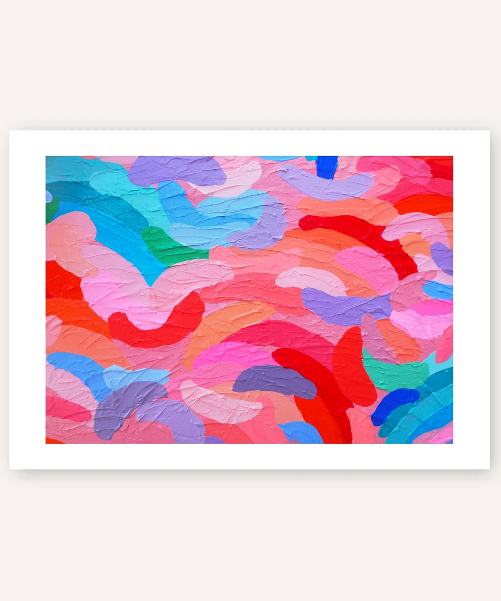A framed abstract art print featuring textured, thick brushstrokes in a vibrant mix of pink, red, blue, purple, and green, displayed against a light beige background.