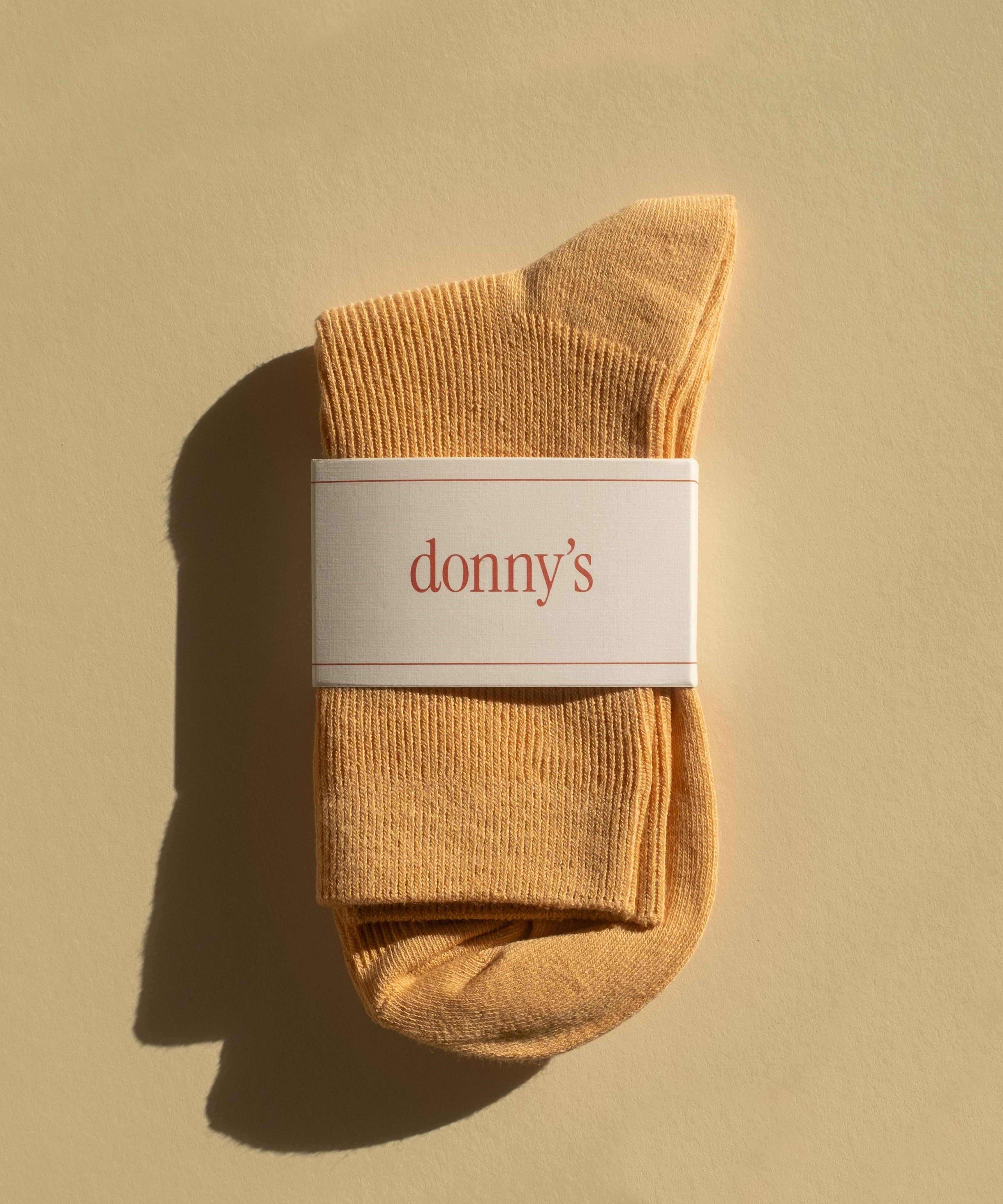 Pair of classic rib socks in almond colour in their packaging