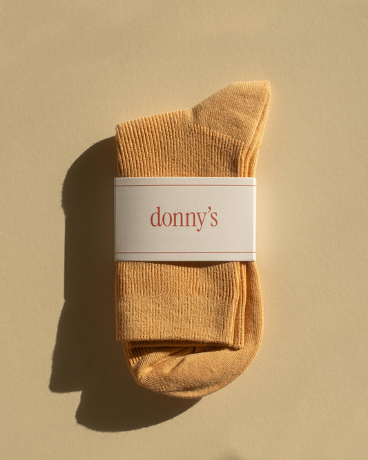 Pair of classic rib socks in almond colour in their packaging