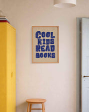 Room interior with a yellow cabinet, wooden stool, and framed poster on the wall.