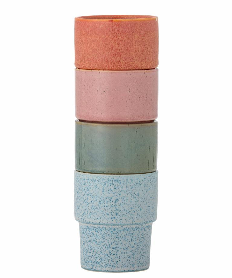Stack of three ceramic cups with different colored finishes on a white background