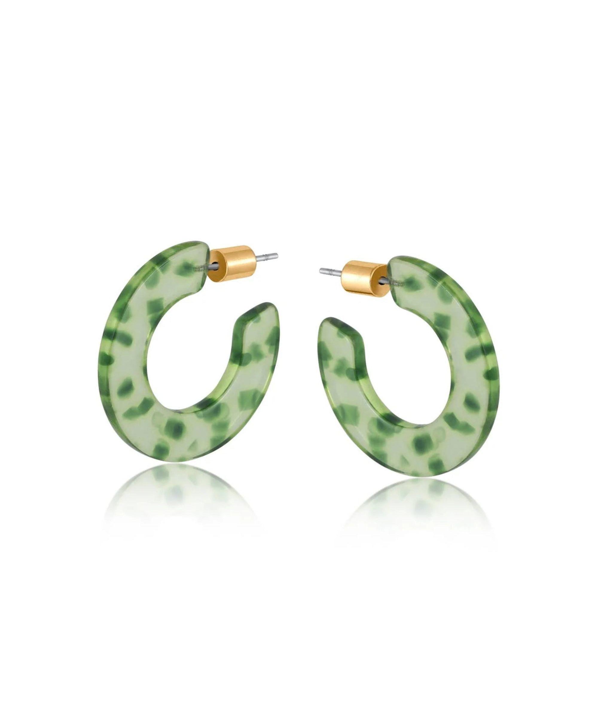 Green resin hoop earrings with dark green flecks and a brass butterfly